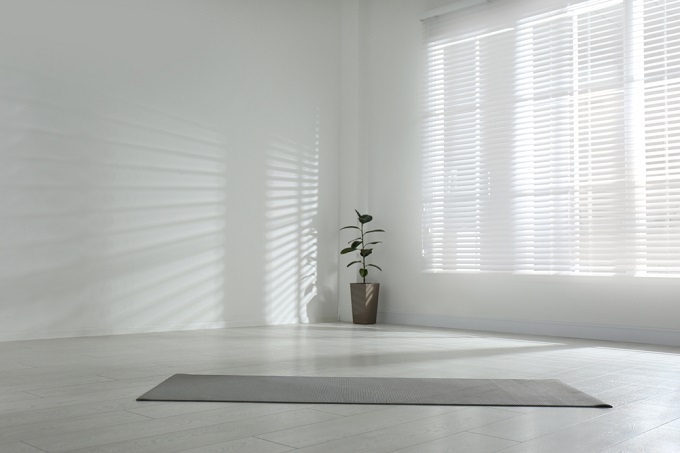 Unrolled grey yoga mat on floor