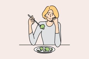Unhappy anorexic woman suffer eating food